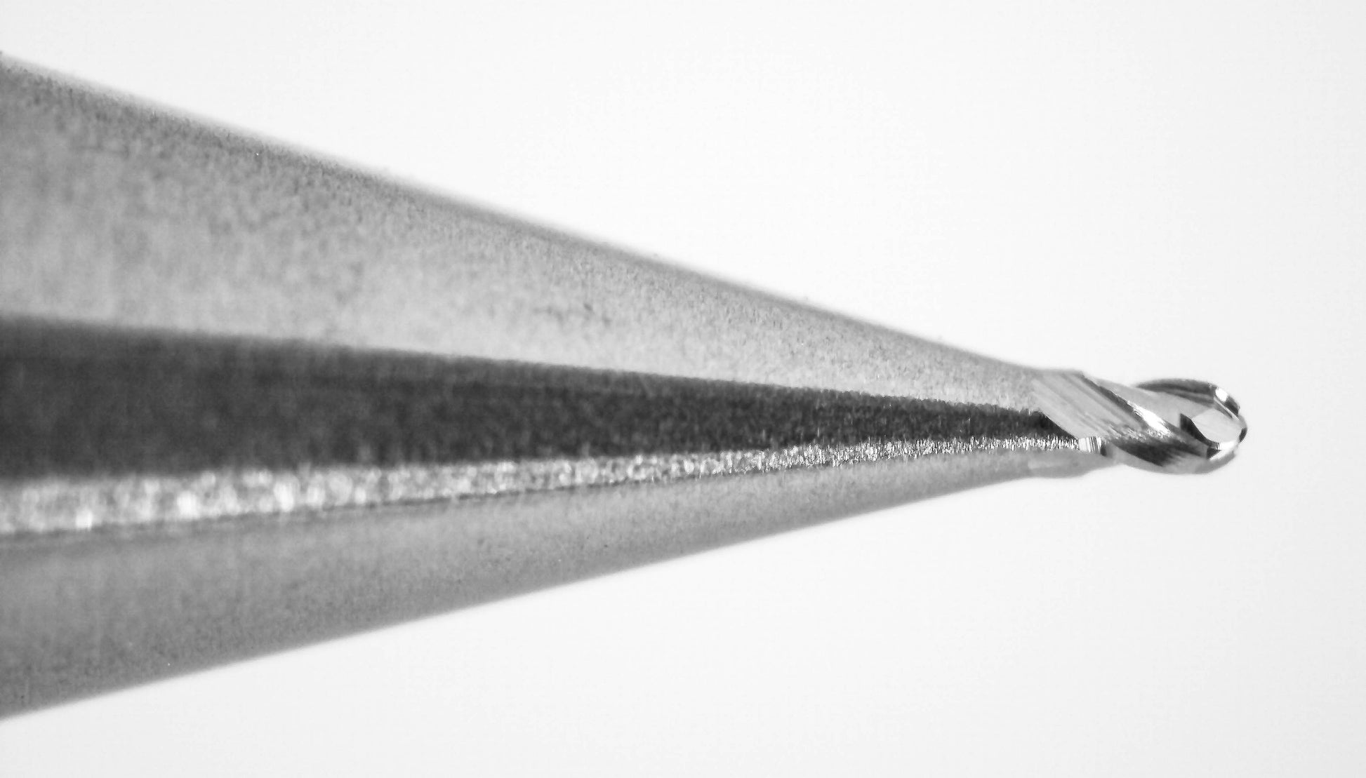 cutting tip close up of 0.011 inch 4 flute carbide ball nose end mill Kyocera 1835-0110.016