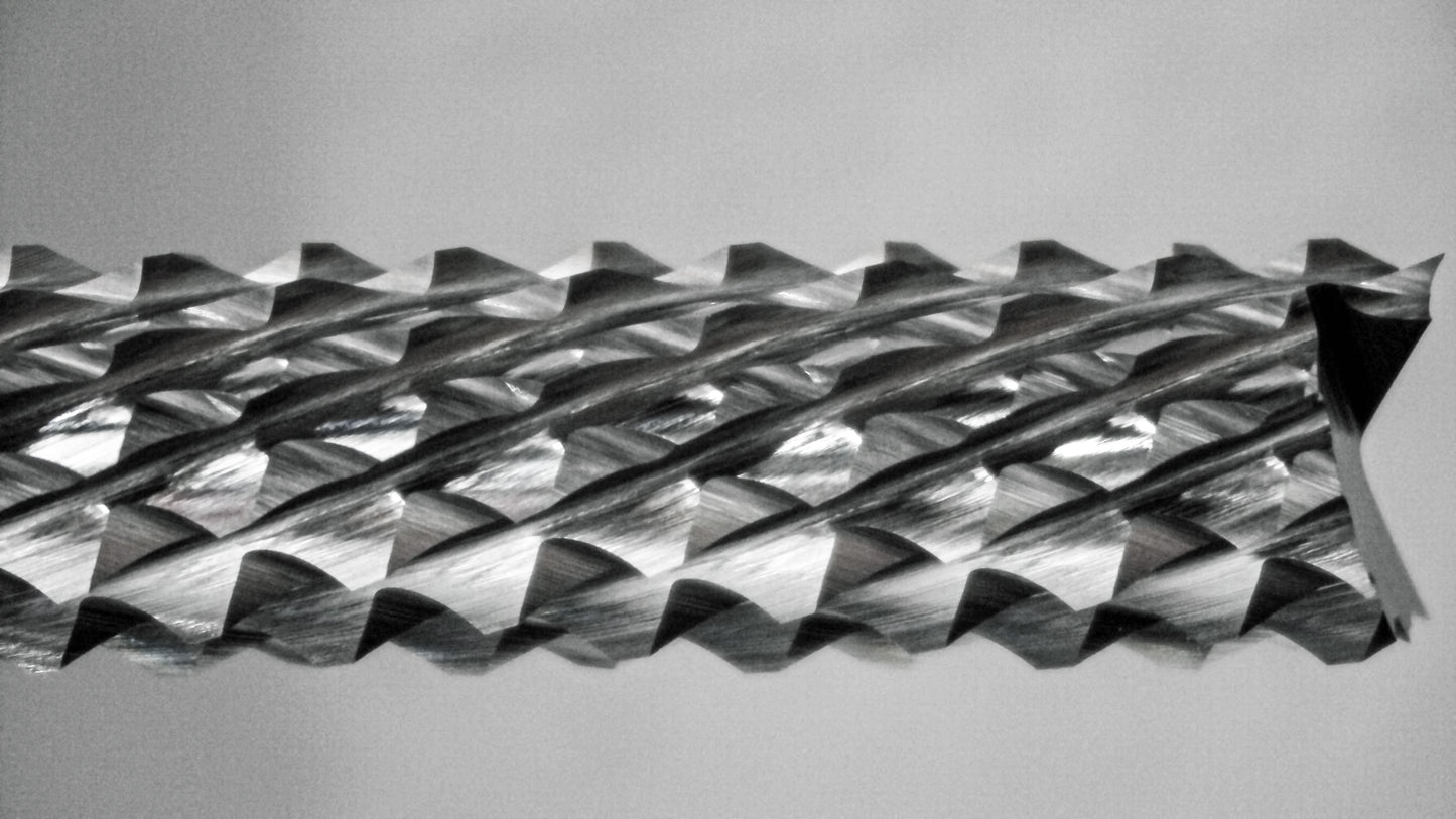 Close-up of fish tail tip and down cut diamond pattern flutes on 1/4 carbide router bit