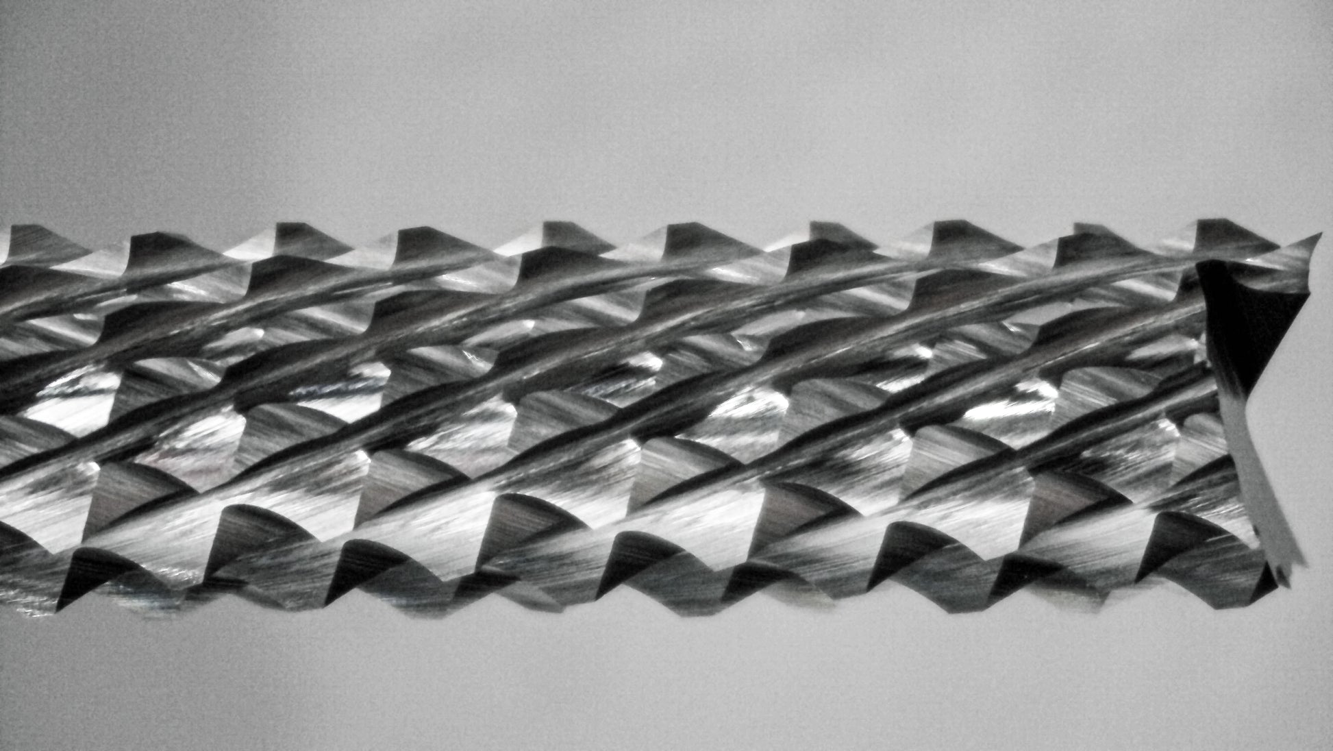 Close-up of fish tail tip and down cut diamond pattern flutes on 1/4 carbide router bit
