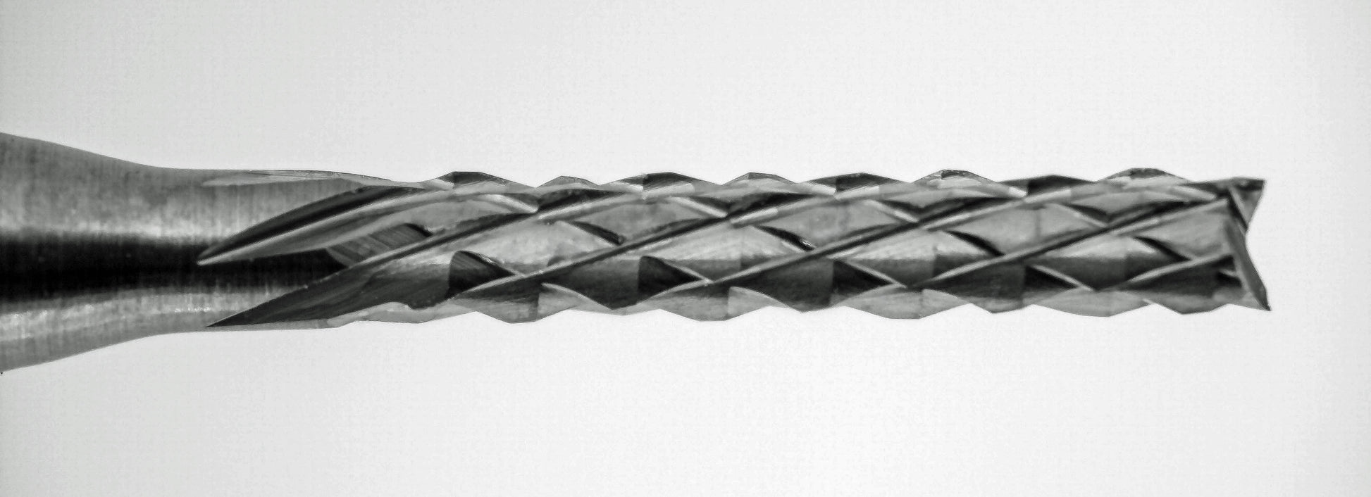 Close-up of fish tail tip and down cut diamond pattern flutes on 1/16 carbide router bit